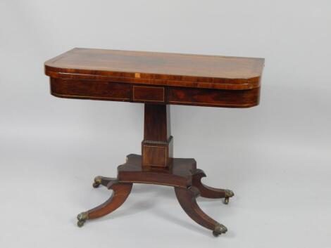 A Regency rosewood and brass inlaid fold over card table