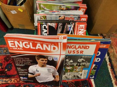 A quantity of England international football programmes