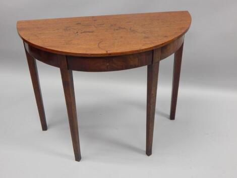 An early 19thC mahogany half round side table