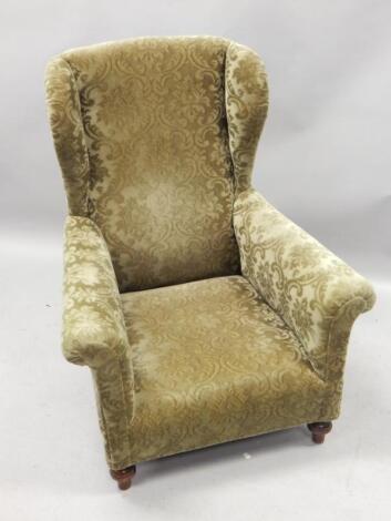 An Edwardian mahogany wingback chair