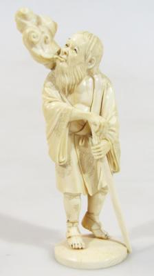 A Japanese Meiji period ivory figure of a gentleman