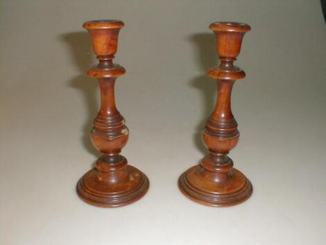 A pair of treen candlesticks