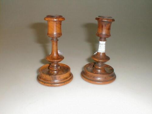 A pair of treen candlesticks