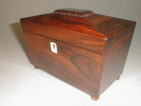 A Victorian rosewood tea caddy of sarcophagus form with a gadrooned cabinet