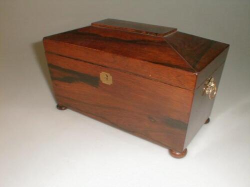 A 19thC rosewood tea caddy of sarcophagus form with stamped brass ring