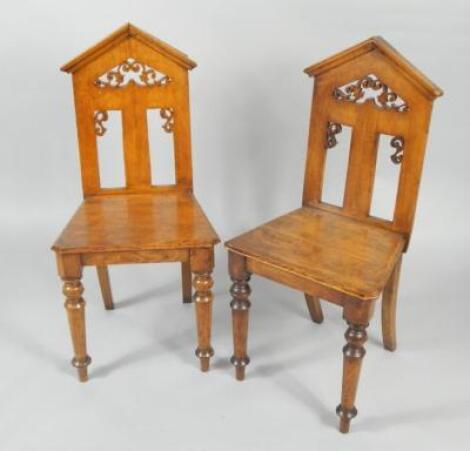 A pair of Victorian Gothic oak hall chairs