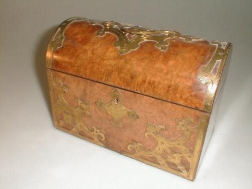 A 19thC burr walnut tea caddy of oblong form with a domed lid with applied