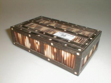 A 19thC Prisoner of War quill box with a sliding lid enclosing a set of bone dominoes