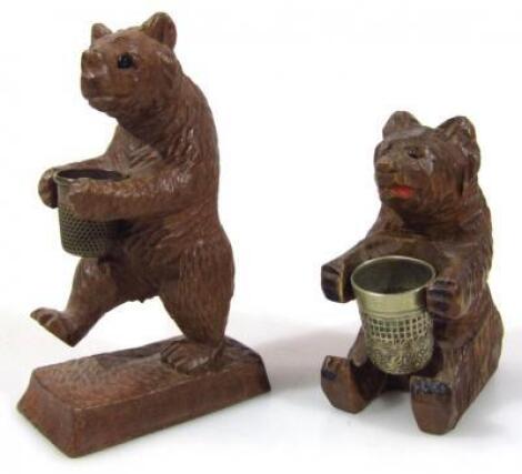 A heavily carved Black Forest bear thimble stand