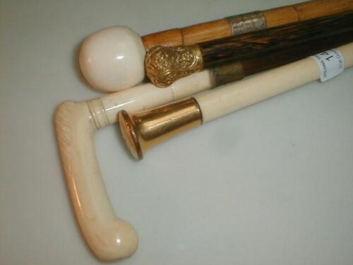 A bamboo walking stick with ivory knob handle and silver ferrule; a stick