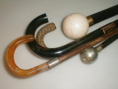 Three walking sticks and a military swagger stick (4)