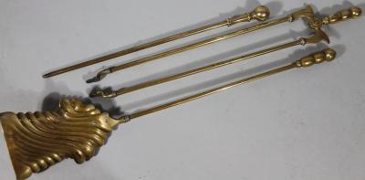 A Regency style brass fireside companion set