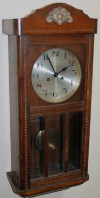 An early 20thC oak cased wall clock