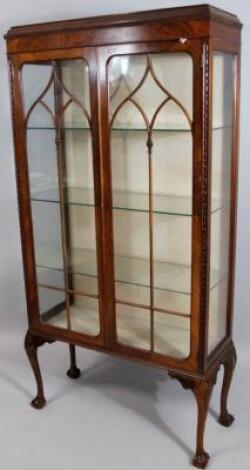 A 20thC walnut display cabinet