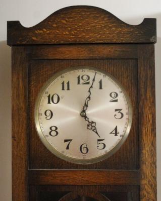 An early 20thC oak cased longcase clock