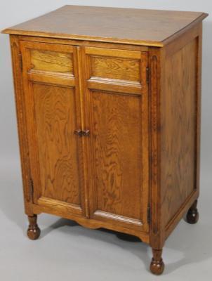 An early 20thC Academy Furnishings oak specimen cabinet