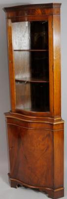 A 20thC walnut and mahogany corner display cabinet