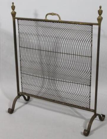 An Edwardian brass fire screen