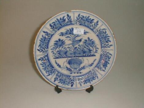 An 18thC Delft plate, the slightly dished centre painted in blue with a