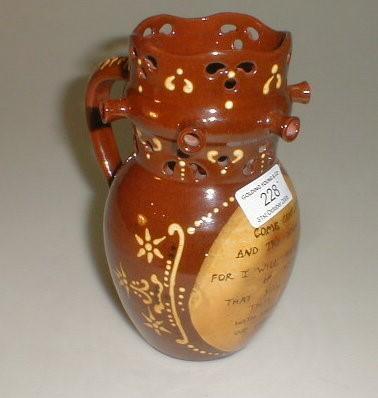 A reproduction slip ware puzzle jug