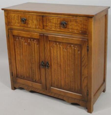 A 20thC Old Court light oak finish side cabinet