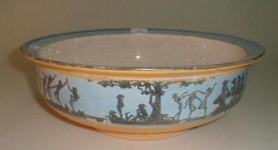 An early 20thC yellow glazed pottery toilet bowl