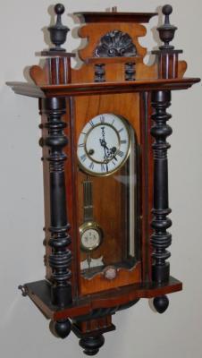 A late 19thC walnut and ebonised Vienna wall clock