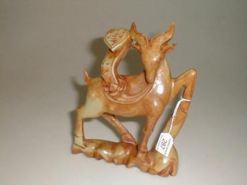 A Chinese soapstone or bowenite figure of a prancing deer