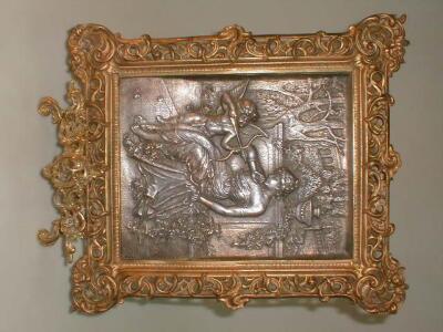 A silvered relief cast plaque