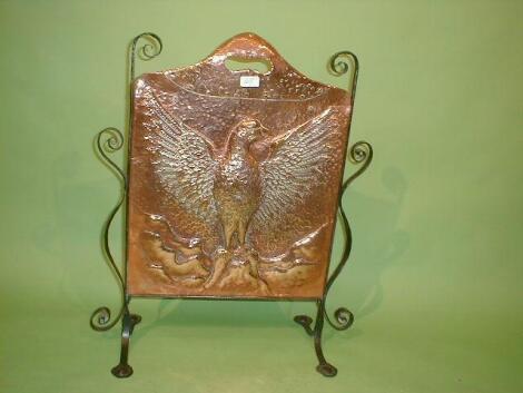 An Arts and Crafts copper fire screen repouss£ with an eagle