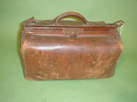 A leather Gladstone bag