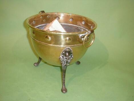 A brass log cauldron with ovoid form with boss border