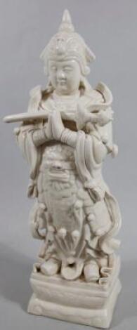 A 20thC semi porcelain blanc-de-chine Chinese figure of a god in flowing robes