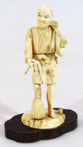 A 19thC ivory figure of a workhand