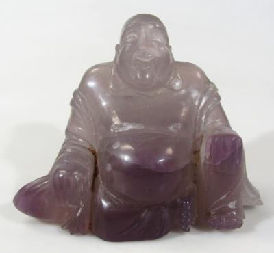 A 20thC Chinese amethyst coloured glass sculpture of Buddha