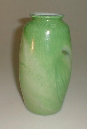 A green and white marbled glass baluster vase