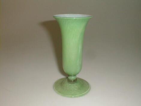 A green and white marbled glass footed vase with flared rim