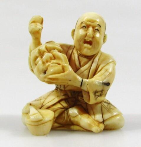 A 19thC Japanese ivory netsuke formed as seated gentleman
