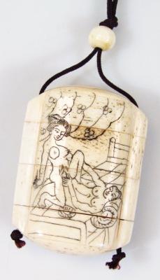 An early 20thC erotic carved bone four sectional Japanese pill box netsuke