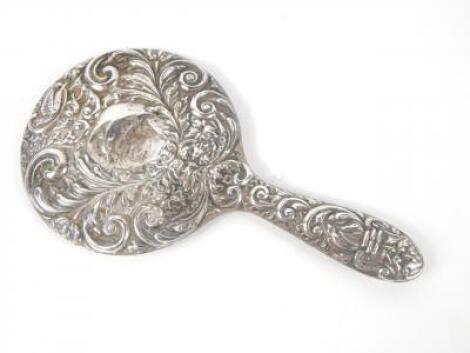 A silver hand mirror embossed with masks