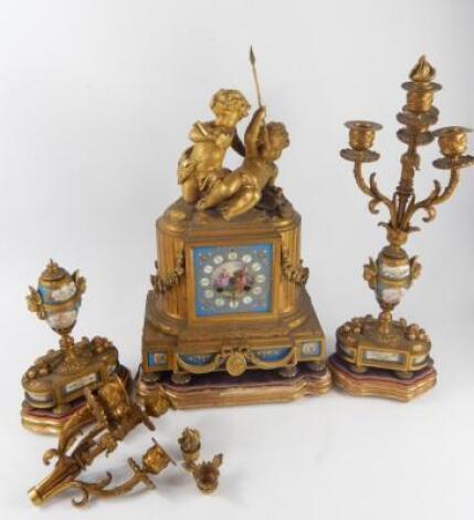 A French late 19thC ormolu and porcelain clock garniture by Japy Freres Et Cie