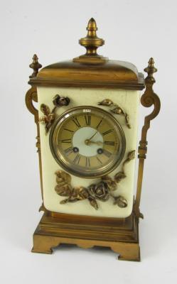 A French early 20thC burnished brass and pottery mantel clock