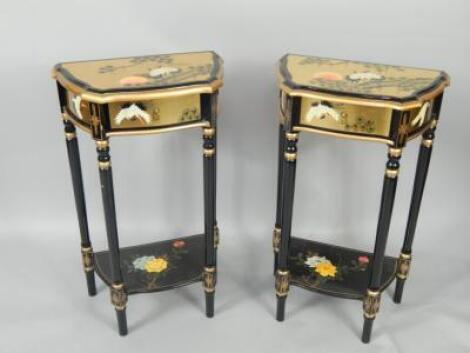 A pair of gilt and black lacquered serpentine side tables