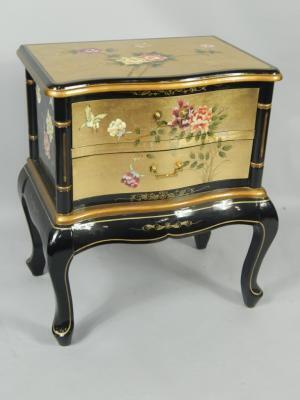 A gilt and black lacquered serpentine chest