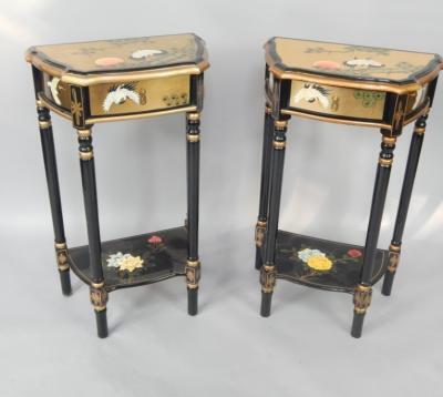 A pair of gilt and black lacquered serpentine side tables