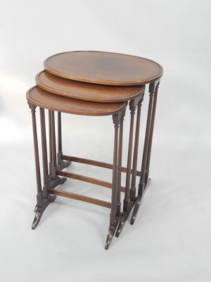 A nest of oval mahogany occasional tables