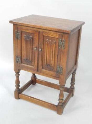 An Old Charm oak linen fold bedside cupboard