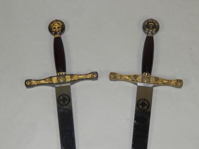 A pair of replica The King Reigns and his son swords