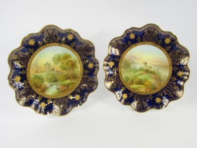 A pair of Aynsley late 19thC porcelain fluted plates painted by R J Keeling