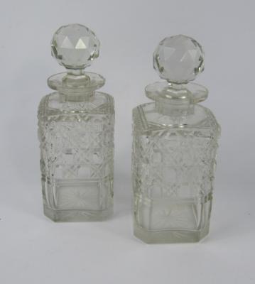 A pair of early 20thC square cut glass decanters and stoppers